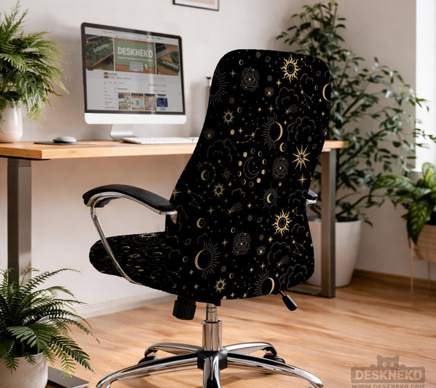 Black chair cover with gold moons, suns, stars, constellations, and line art printed across the fabric.