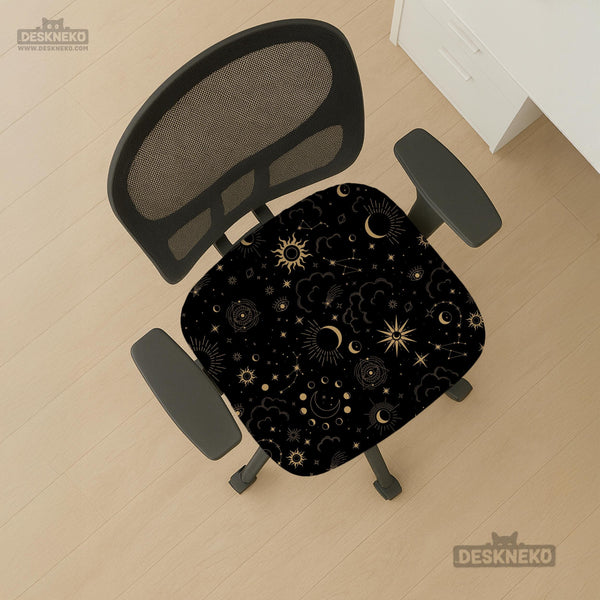 Black chair cover with gold moons, suns, stars, constellations, and line art printed across the fabric.