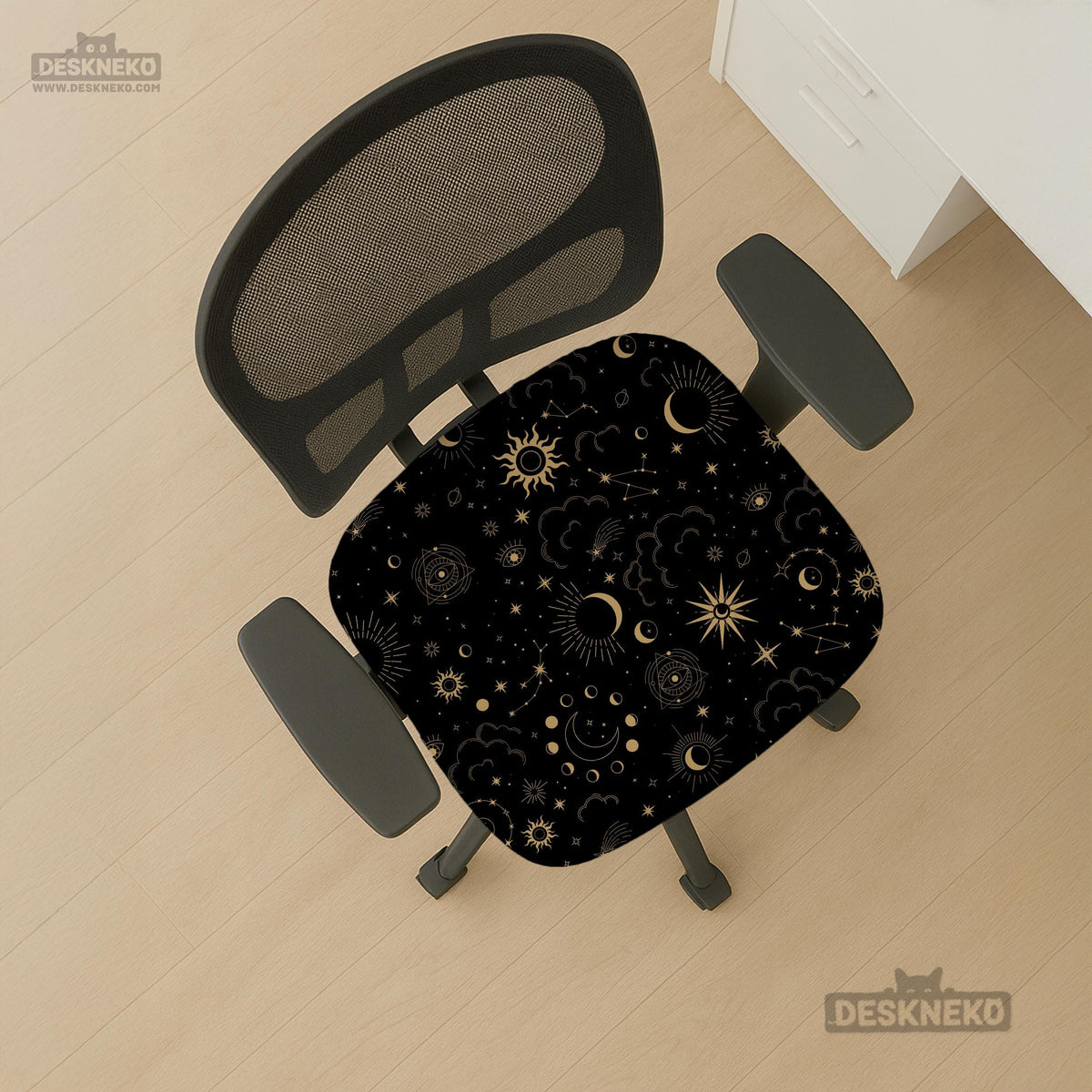 Black chair cover with a gold astrology print of moons, suns, stars, and symbols on a gaming chair.
