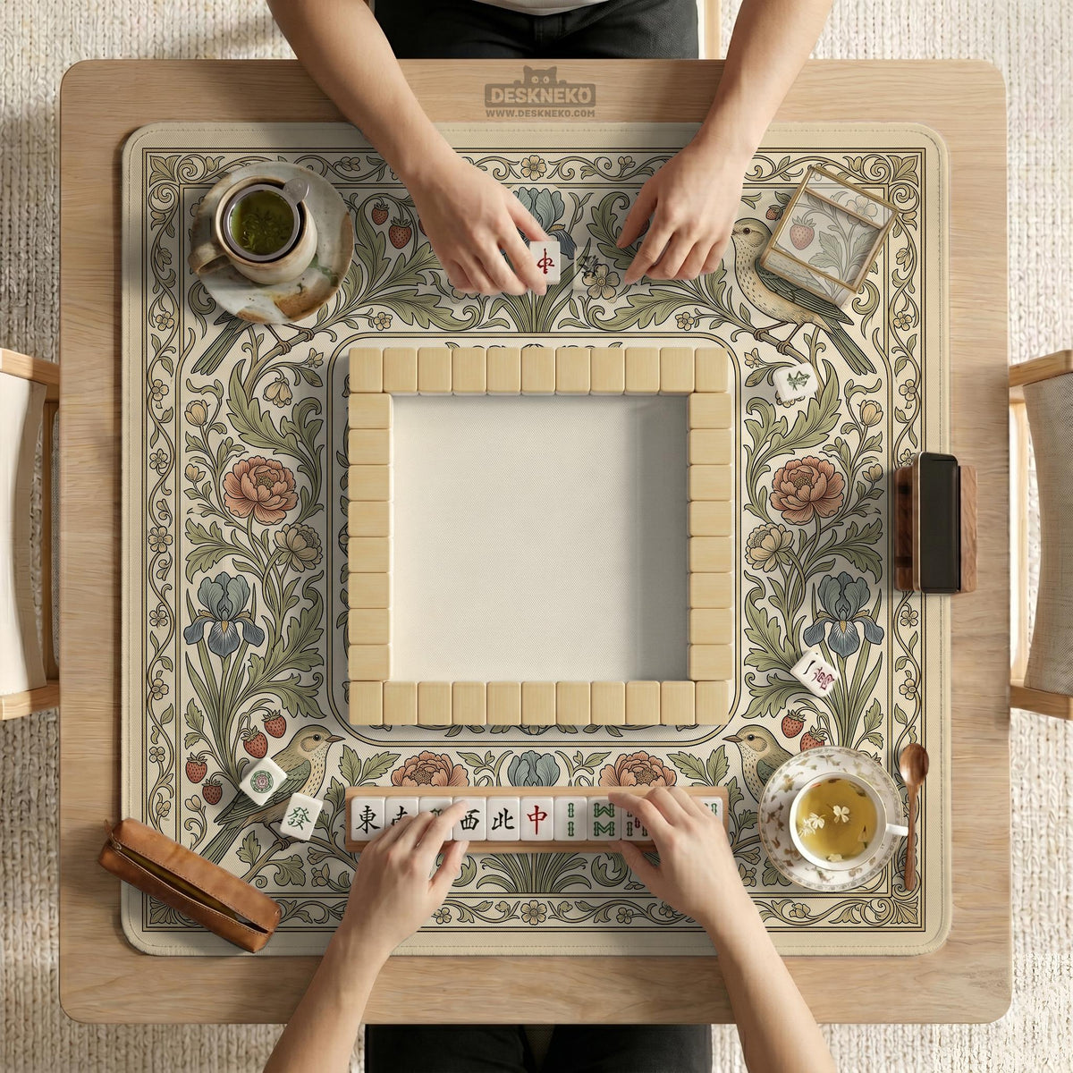 Square mahjong table mat with vintage bird artwork, floral border detail, and sage green, cream, muted blue, and terracotta tones.