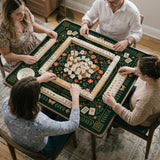 Dark botanical mahjong table mat with a floral border, large moth and butterfly design in the center, gold corner frame, and printed rules layout around the edge.
