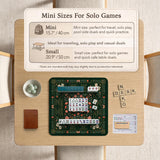 Dark botanical mahjong table mat with a floral border, large moth and butterfly design in the center, gold corner frame, and printed rules layout around the edge.