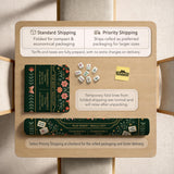Dark botanical mahjong table mat with a floral border, large moth and butterfly design in the center, gold corner frame, and printed rules layout around the edge.