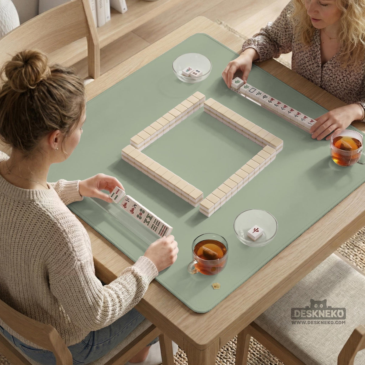 A plain light sage green square mahjong mat with a smooth solid-color surface.