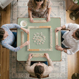 A plain light sage green square mahjong mat with a smooth solid-color surface.