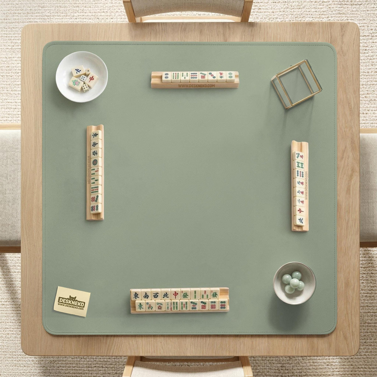 A plain light sage green square mahjong mat with a smooth solid-color surface.