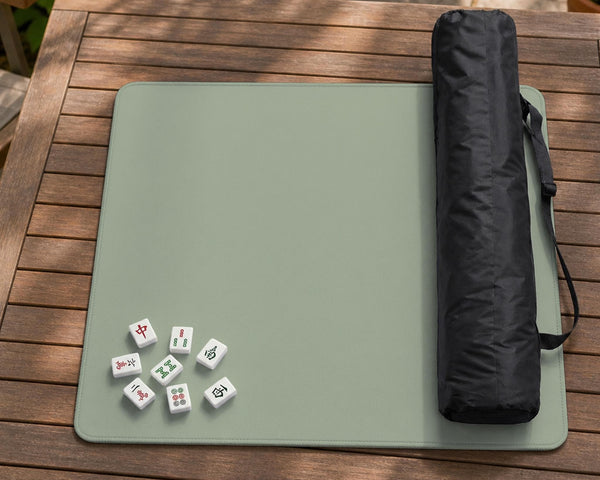 A plain light sage green square mahjong mat with a smooth solid-color surface.