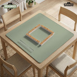 A plain light sage green square mahjong mat with a smooth solid-color surface.