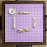 Lavender gingham mahjong mat with a scalloped edge and a pastel check pattern.