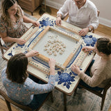 Blue and white mahjong table mat with a floral border, small birds, pagoda details, striped center, and printed rules around the edge.