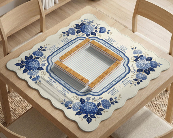 Blue and white mahjong table mat with a floral border, small birds, pagoda details, striped center, and printed rules around the edge.