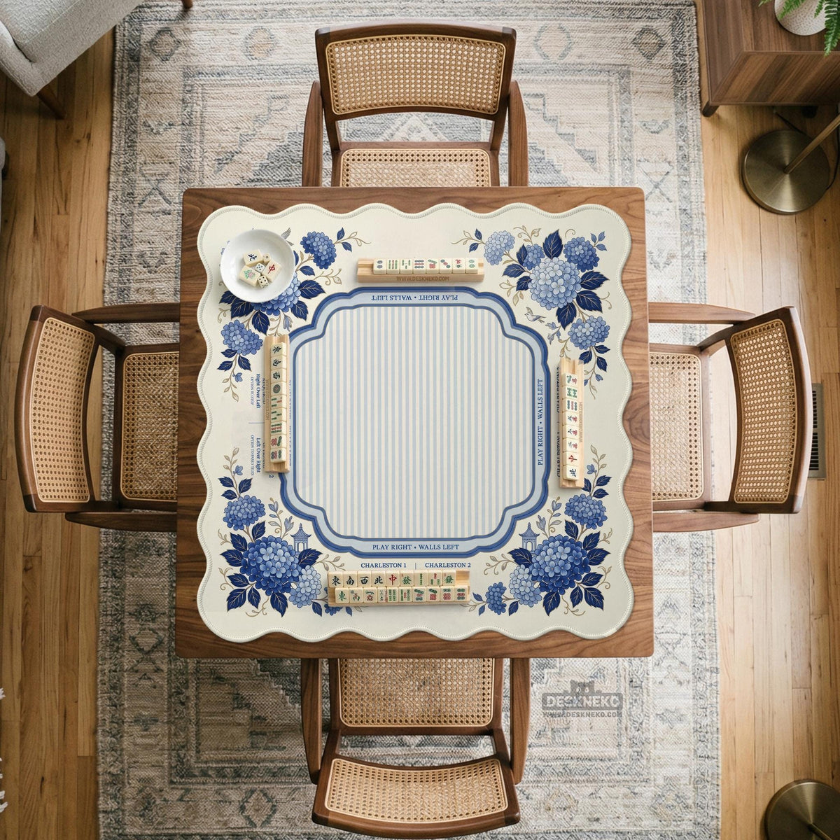Blue and white mahjong table mat with a floral border, small birds, pagoda details, striped center, and printed rules around the edge.