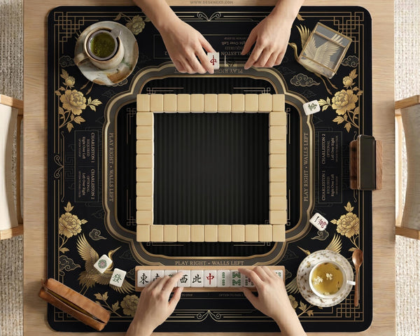 Black and gold square mahjong mat with an art deco crane and floral border, rule reminders around the edges, and a blank center area.