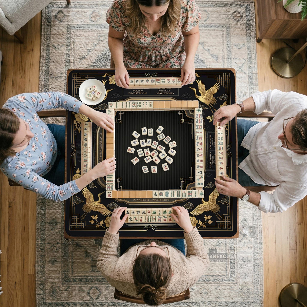 Black and gold square mahjong mat with an art deco crane and floral border, rule reminders around the edges, and a blank center area.