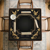 Black and gold square mahjong mat with an art deco crane and floral border, rule reminders around the edges, and a blank center area.