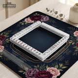 Burgundy mahjong mat with a floral border, gold botanical details, and printed American Mahjong rules on a dark background.