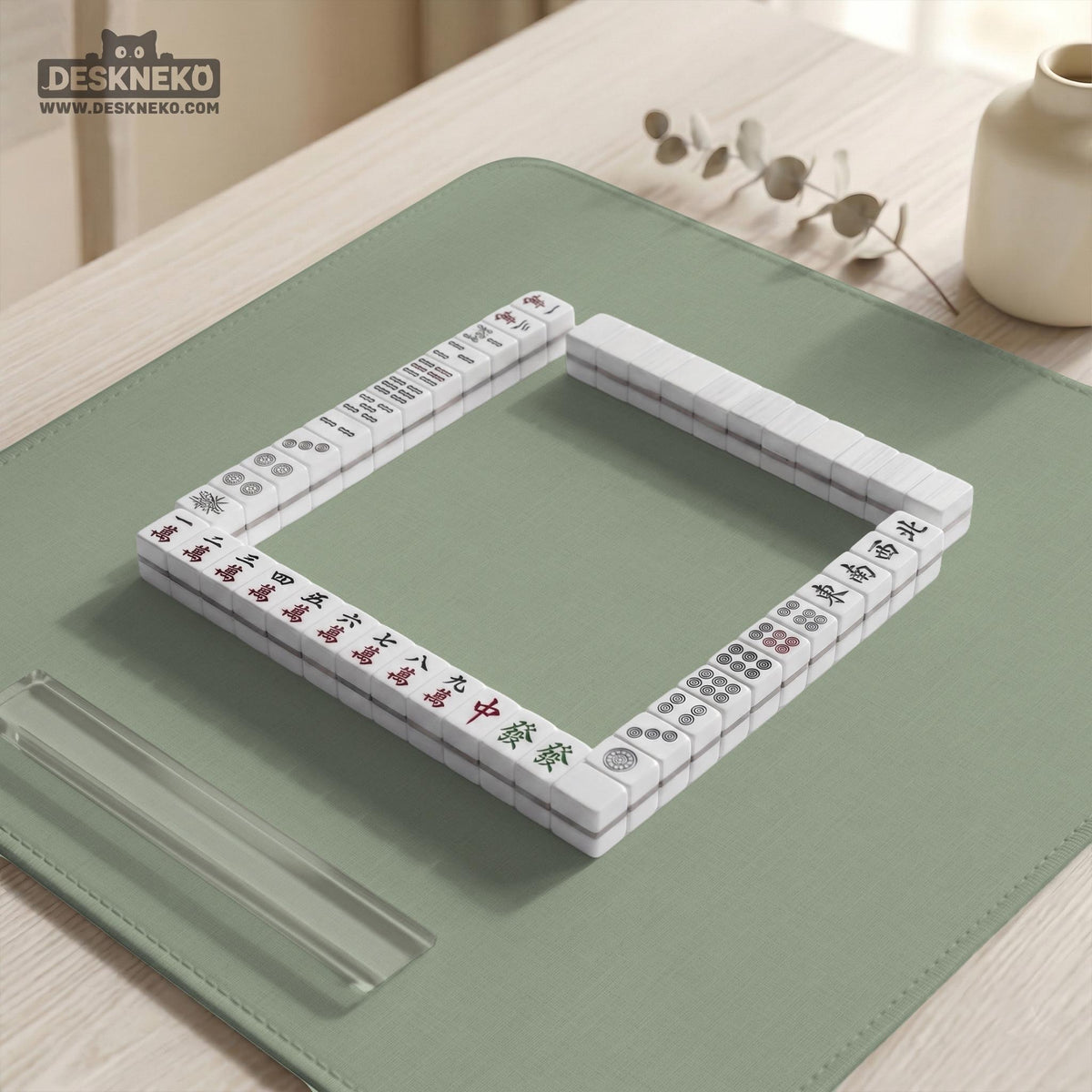 A square sage green mahjong mat with scalloped edges on a plain background.