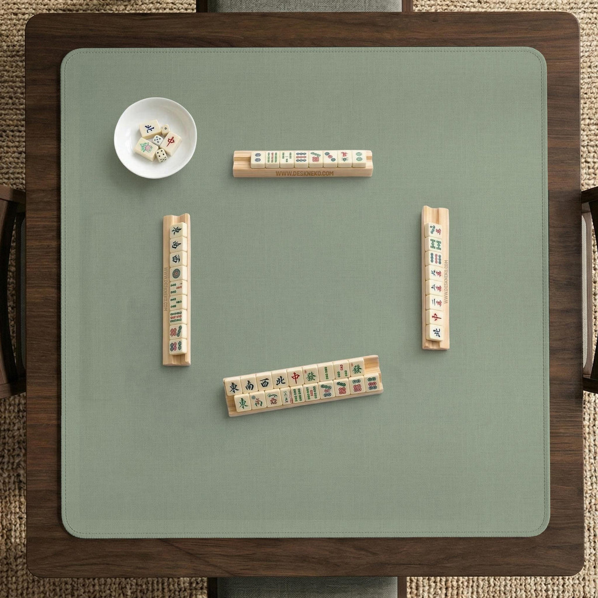 A square sage green mahjong mat with scalloped edges on a plain background.