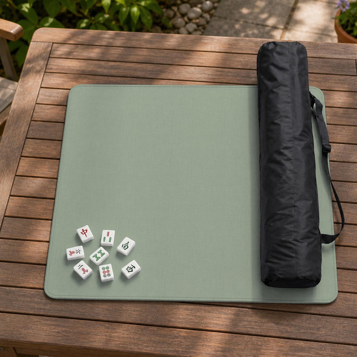 A square sage green mahjong mat with scalloped edges on a plain background.