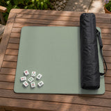 A square sage green mahjong mat with scalloped edges on a plain background.