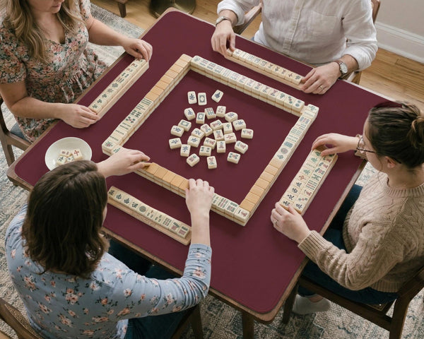 Plain burgundy square mahjong mat with scalloped edges on a white background.