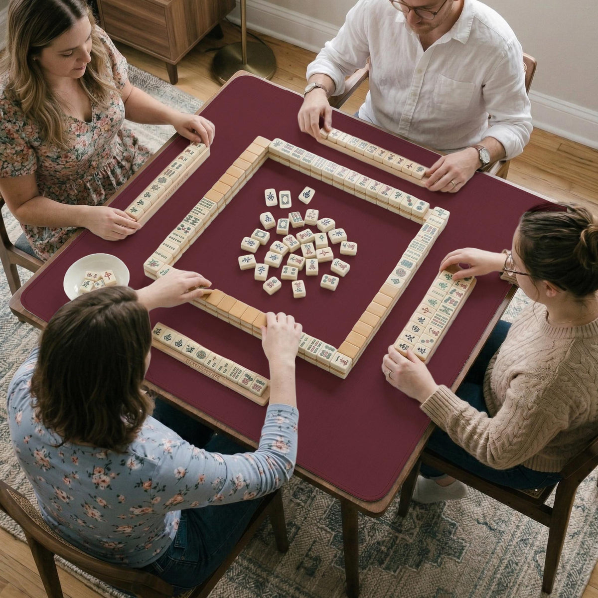 Plain burgundy square mahjong mat with scalloped edges on a white background.