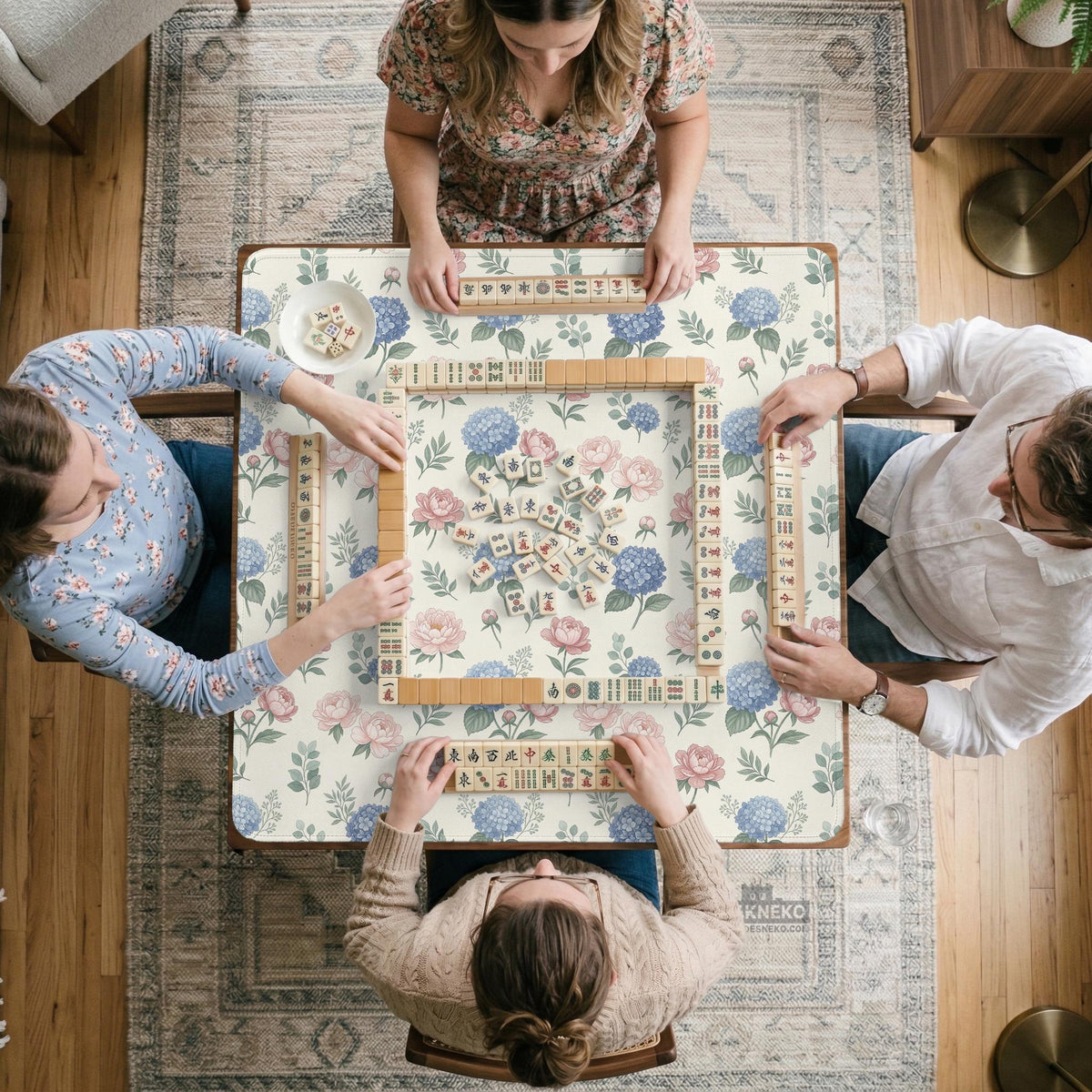 Pink floral mahjong table mat with peonies, blue hydrangeas, sage green leaves, and an ivory background.