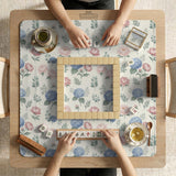 Pink floral mahjong table mat with peonies, blue hydrangeas, sage green leaves, and an ivory background.
