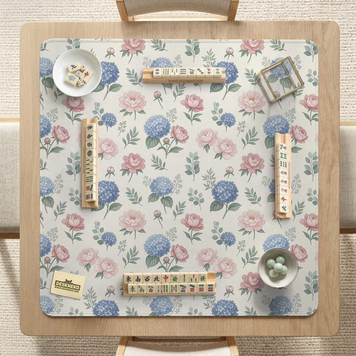 Pink floral mahjong table mat with peonies, blue hydrangeas, sage green leaves, and an ivory background.