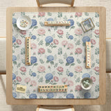 Pink floral mahjong table mat with peonies, blue hydrangeas, sage green leaves, and an ivory background.