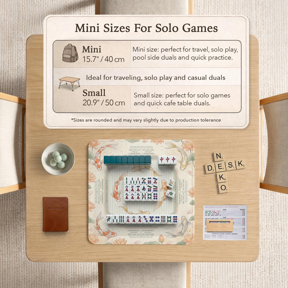 Sage and cream mahjong mat with a koi fish pond pattern, lotus blooms, water ripples, and printed instructions around the border. One version has a scalloped edge.