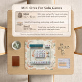 Sage and cream mahjong mat with a koi fish pond pattern, lotus blooms, water ripples, and printed instructions around the border. One version has a scalloped edge.