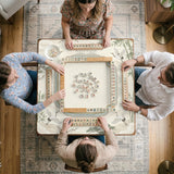 Sage green scalloped mahjong mat with bamboo, crane, and blossom illustration and printed rules around the border.