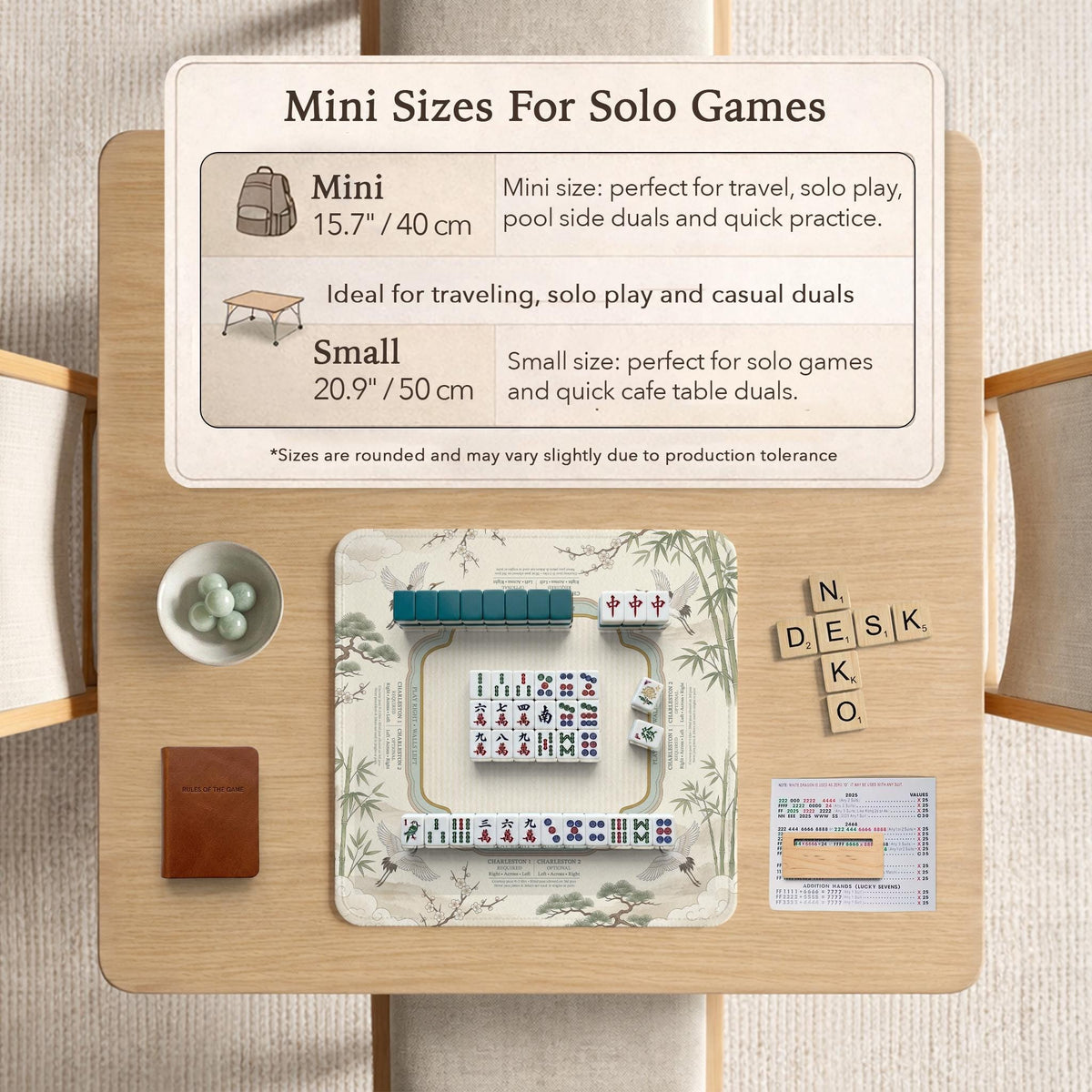 Sage green scalloped mahjong mat with bamboo, crane, and blossom illustration and printed rules around the border.