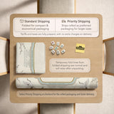 Sage green scalloped mahjong mat with bamboo, crane, and blossom illustration and printed rules around the border.