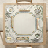 Sage green scalloped mahjong mat with bamboo, crane, and blossom illustration and printed rules around the border.