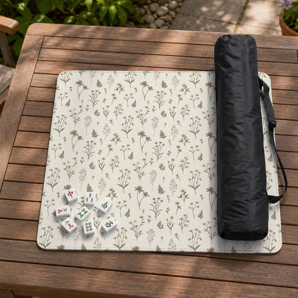 Cream mahjong mat with a floral pattern of small wildflowers and sage leaves, shown with a scalloped edge on a light neutral background.
