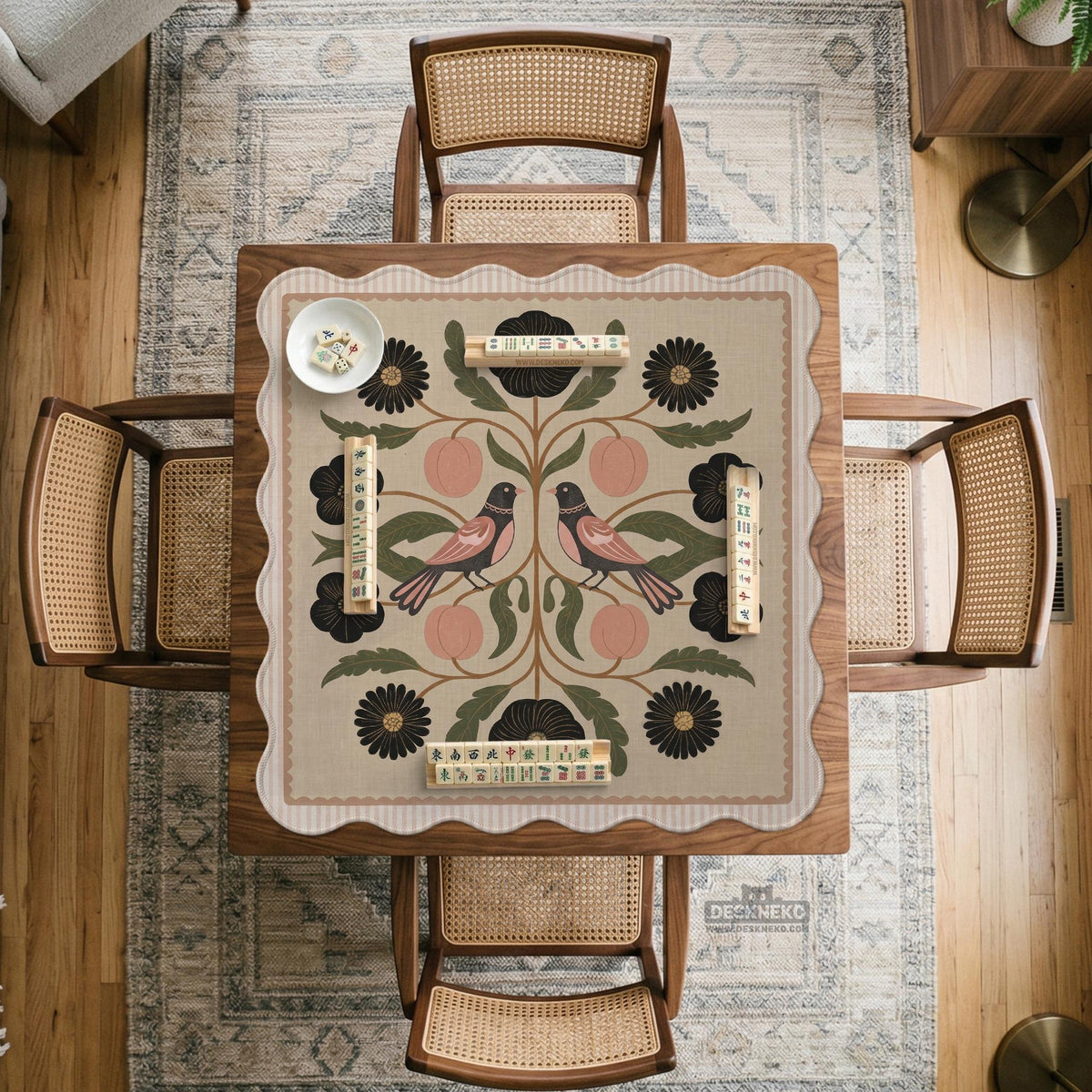 Beige mahjong mat with a botanical floral bird design, blush flowers, olive green leaves, black flower accents, and a warm linen-style background. Scalloped edge option shown.