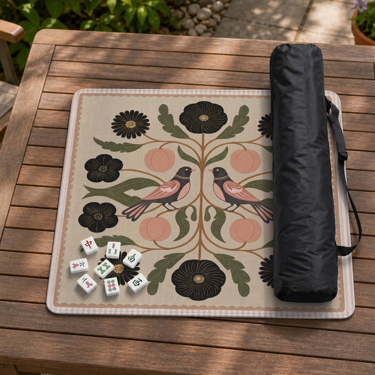 Beige mahjong mat with a botanical floral bird design, blush flowers, olive green leaves, black flower accents, and a warm linen-style background. Scalloped edge option shown.