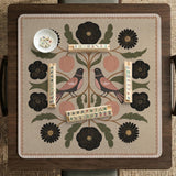 Beige mahjong mat with a botanical floral bird design, blush flowers, olive green leaves, black flower accents, and a warm linen-style background. Scalloped edge option shown.