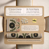 Beige mahjong mat with a botanical floral bird design, blush flowers, olive green leaves, black flower accents, and a warm linen-style background. Scalloped edge option shown.