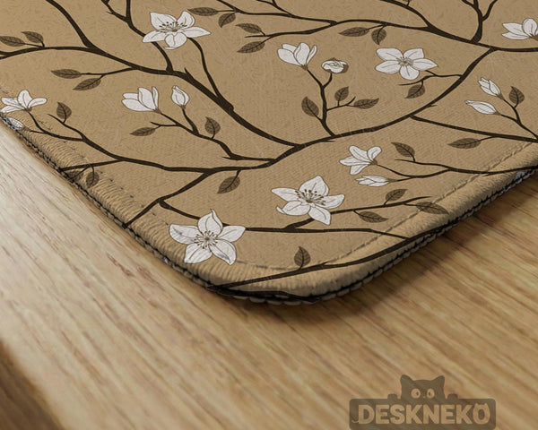 Beige mahjong mat with a white blossom branch floral pattern on a neutral background.
