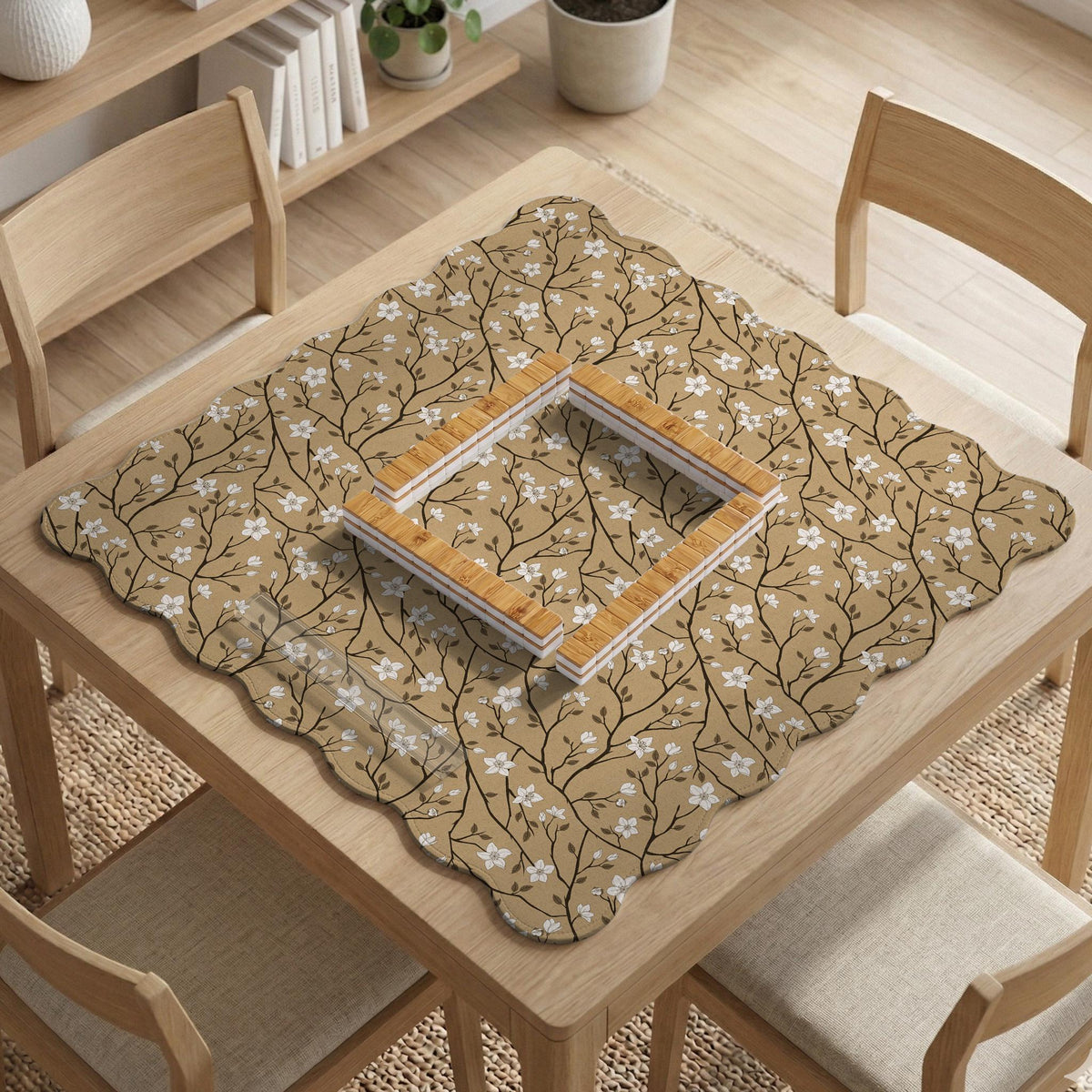 Beige mahjong mat with a white blossom branch floral pattern on a neutral background.