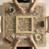 Beige mahjong mat with a white blossom branch floral pattern on a neutral background.