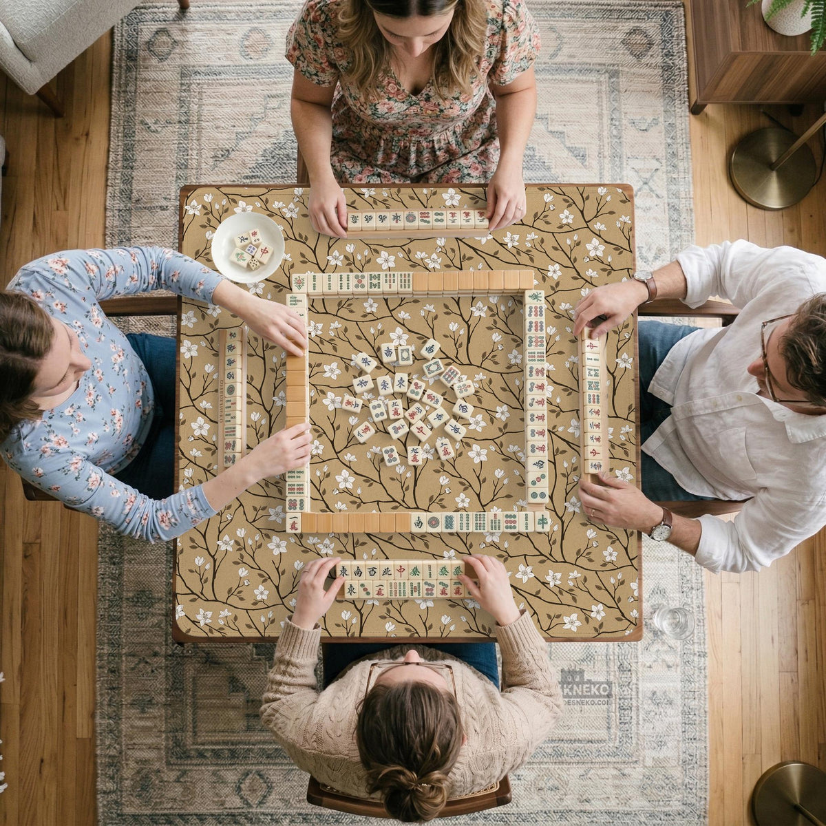 Beige mahjong mat with a white blossom branch floral pattern on a neutral background.