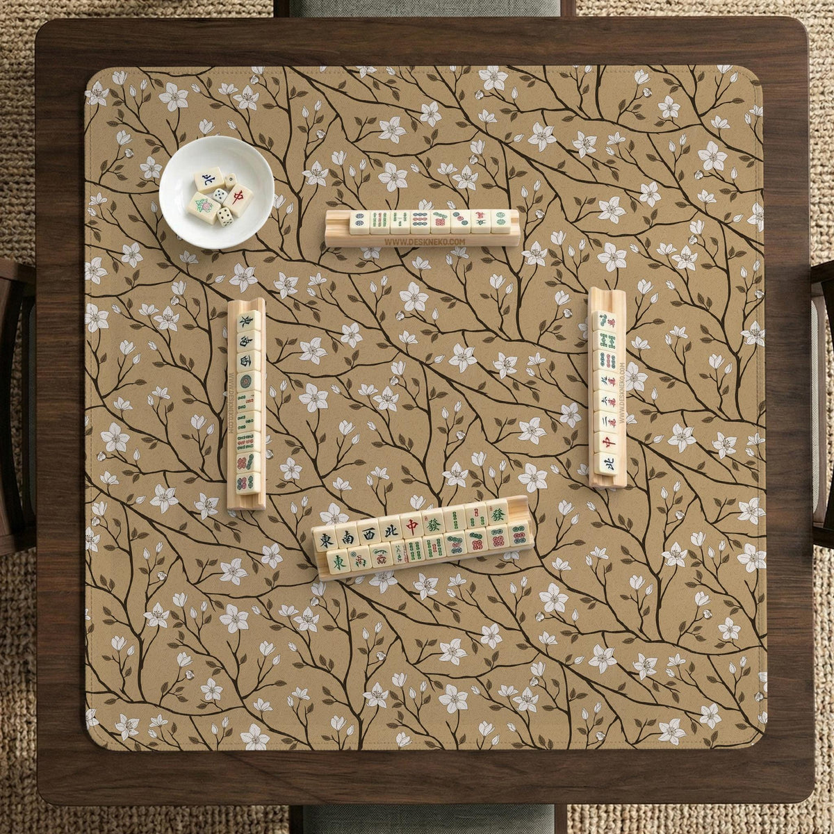 Beige mahjong mat with a white blossom branch floral pattern on a neutral background.