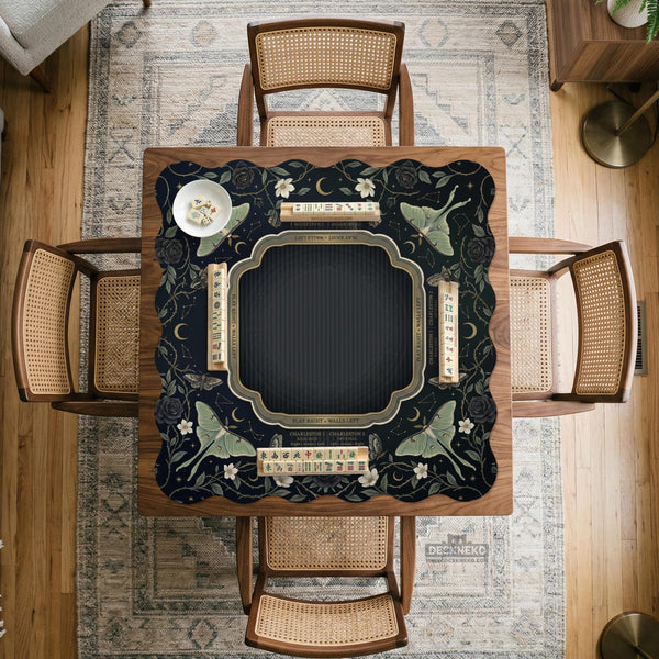 A dark floral mahjong mat with a scalloped edge, moth and flower artwork, and an American Mahjong rules layout on a dark background.