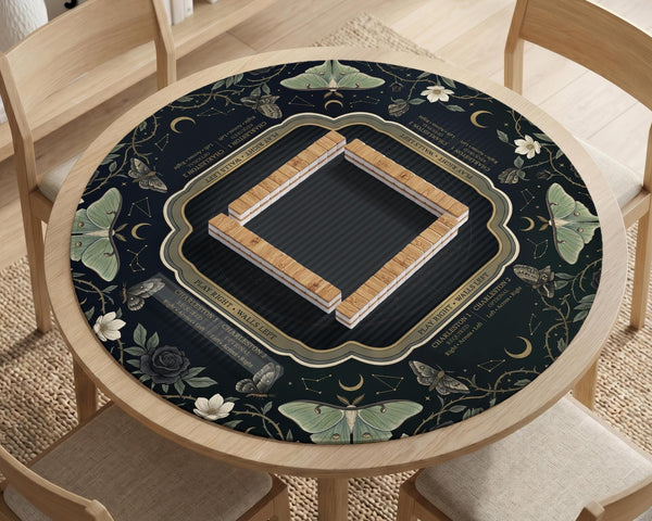 A dark floral mahjong mat with a scalloped edge, moth and flower artwork, and an American Mahjong rules layout on a dark background.