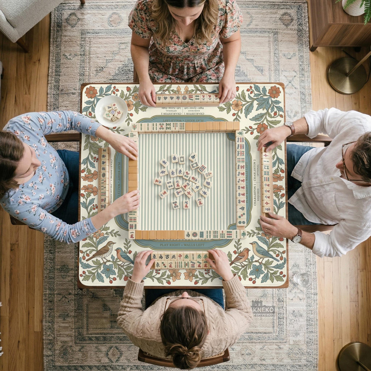 Square mahjong mat with a cream background, blue birds, sage leaves, terracotta flowers, and a decorative botanical border with printed rules text.