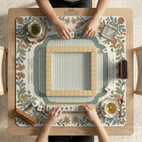 Square mahjong mat with a cream background, blue birds, sage leaves, terracotta flowers, and a decorative botanical border with printed rules text.